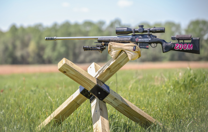 Holding up a competition rifle on a tank trap obstacle.  Shmedium Mid-Sized Gamechanger™ with Pigg River Logo - Sharps Mountain - Pigg River Precision - Sharpsmountain.com