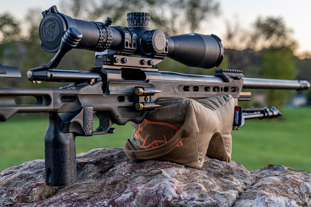 Holding up a mpa ba competition rifle with orange pigg logo visible Shmedium Mid-Sized Gamechanger™ with Pigg River Logo - Sharps Mountain - Pigg River Precision - Sharpsmountain.com