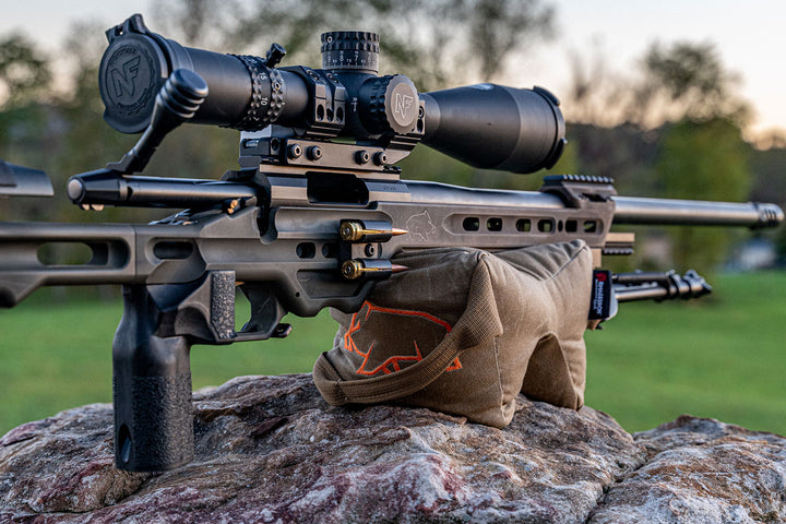 Holding up a mpa ba competition rifle with orange pigg logo visible Shmedium Mid-Sized Gamechanger™ with Pigg River Logo - Sharps Mountain - Pigg River Precision - Sharpsmountain.com