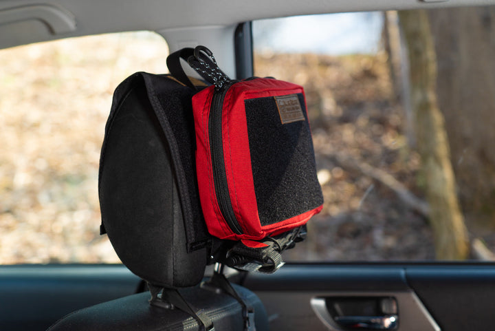 IFAK Velcro Pouch 2.0 - Small, on headrest in vehicle.