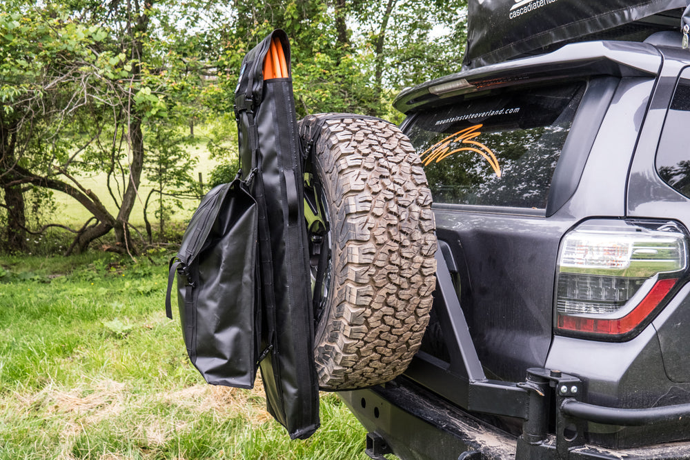 BROG Maxtrax Bag mounted to a 33" tire, with a Tire Storage bag stacked on the outside of it.