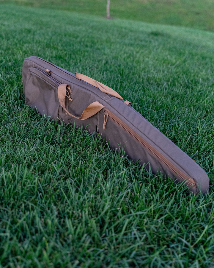 Rifle bag in grass side angle - Armageddon Gear 52 Inch Precision Rifle Case - Sharps Mountain Outdoor Gear - Pigg River Precision