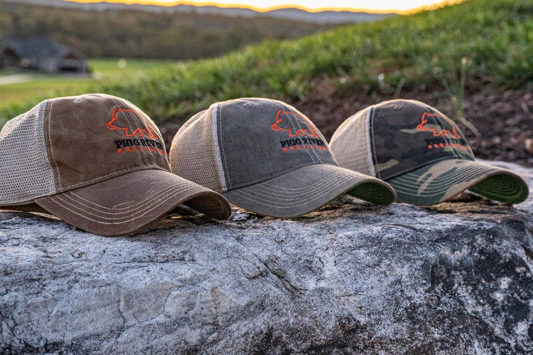 Pigg River Precision Hats grouped on  a rock.- Sharps Mountain - SharpsMountain.com