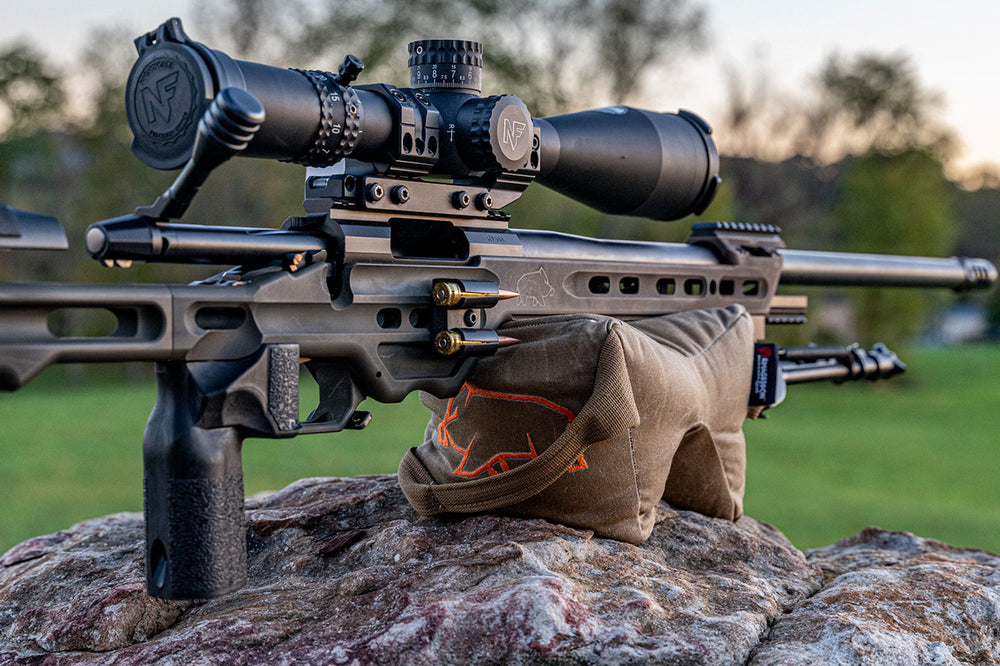 Holding up a mpa ba competition rifle with orange pigg logo visible Shmedium Mid-Sized Gamechanger™ with Pigg River Logo - Sharps Mountain - Pigg River Precision - Sharpsmountain.com