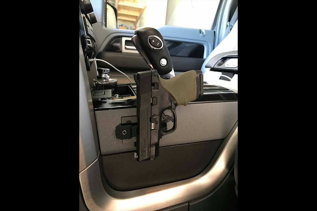 Pistol mounted to the side of car center console with go-magnet. Go-Magnets - Pistol Grab Mount - Sharps Mountain Outdoor Gear