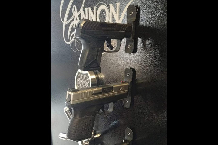 Two pistols sticking out straight from a safe door, held there by go-magnets.  Go-Magnets - Pistol Grab Mount - Sharps Mountain Outdoor Gear